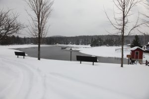 view of old forge pond at the beach, covered in snow