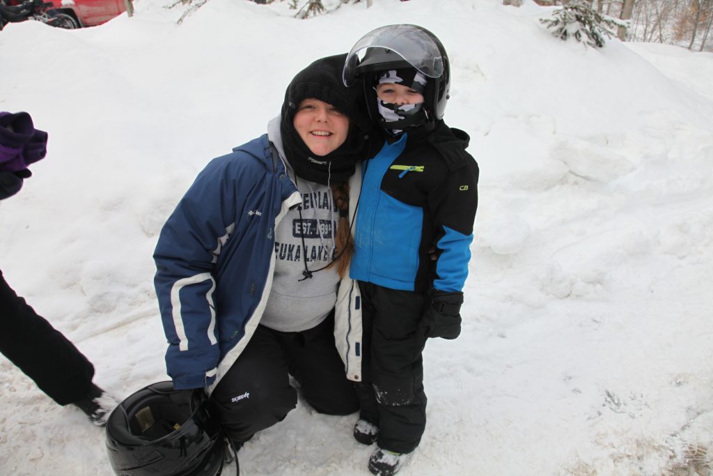 woman and young boy in snowmobiling gear
